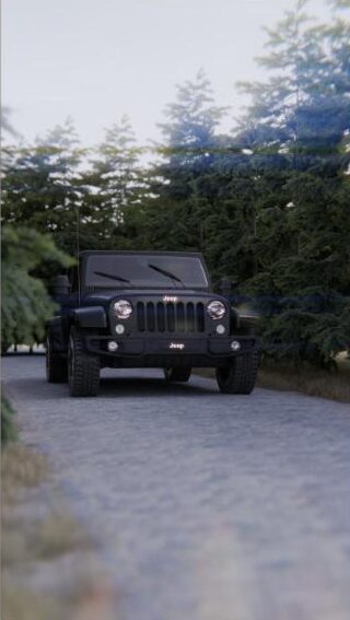 Black Jeep Wrangler driving slowly on a forest service road